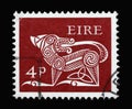 A stamp printed in Ireland shows Stylised Dog, 7th Century Brooch, Early Irish Art