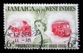 Stamp printed in Jamaica shows and Queen Elizabeth II and coach and bus, the 100th Anniversary of Jamaican Postal Service