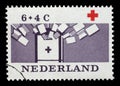 Stamp printed in Netherlands shows Collection box for reading matter, Red Cross series Royalty Free Stock Photo