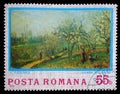Stamp printed in Romania shows Orchard in Bloom, Painting by Camille Pissarro