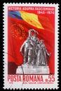 Stamp printed in Romania shows Victory Monument and flags of Romania and USSR