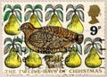 A stamp printed in United Kingdom shows Partridge in a Pear Tree