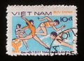 Stamp printed in Vietnam shows Gymnastics, running and swimming, 1st national sports festival