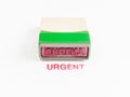 Stamp with urgent in red ink Royalty Free Stock Photo