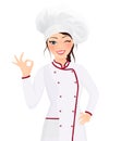 Portrait beautiful smiling young brunette woman cook wearing hat and chef uniform making ok sign gesture looking at the camera. In Royalty Free Stock Photo