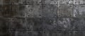 Stamped Concrete Cement Wall. Peeling dark grey mosaic, natural looking tiles