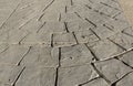 Stamped concrete pavement outdoor, mimics cobblestones circular pattern with waves, decorative appearance colors and textures of Royalty Free Stock Photo