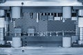 The stamping operation of metal drawing process on the progressive die in the light blue scene Royalty Free Stock Photo