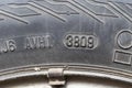Stamping on a tire where date and year of issue are indicated. Close-up. Old wheel, replacement required