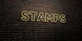 STAMPS -Realistic Neon Sign on Brick Wall background - 3D rendered royalty free stock image