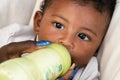 Stand-alone baby. Feeding infant with milk.