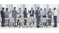Stand around a long table with office chairs holding documents and Royalty Free Stock Photo