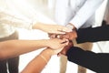 We stand as one. Closeup shot of a group of businesspeople joining their hands together in a huddle. Royalty Free Stock Photo