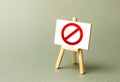 Stand with a canvas and a red prohibition sign NO. Inability to sell products, ban on the import. Restriction on the importation Royalty Free Stock Photo