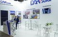 Stand of DAH Solar, the manufacturer of smart PV modules, manager working. CISOLAR exhibition. Kyiv, Ukraine