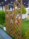 Stand decor made of wooden fencing and green grass in exhibition. Landscaping from natural materials. Landscape design. Care for p Royalty Free Stock Photo