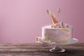 Stand with delicious birthday cake on table against color background Royalty Free Stock Photo