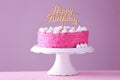 Stand with delicious birthday cake on table against color background Royalty Free Stock Photo