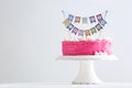 Stand with delicious birthday cake on table against light background Royalty Free Stock Photo