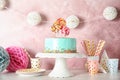 Stand with fresh delicious cake and birthday decorations Royalty Free Stock Photo