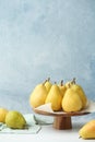 Stand with fresh ripe pears on table