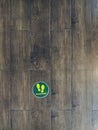 STAND HERE foot sign or symbol on the wooden floor in coffee shop. Coffee shop set foot sign for social distancing to order coffee Royalty Free Stock Photo