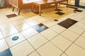 STAND HERE foot sign or symbol on the wooden floor in coffee shop. Coffee shop set foot sign for social distancing to order coffee Royalty Free Stock Photo