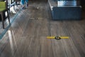 STAND HERE foot sign or symbol on wooden floor in coffee shop. Coffee shop set foot sign for social distancing to order coffee and Royalty Free Stock Photo