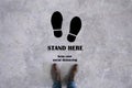 Stand Here Symbol on a man standing background,Concept design for