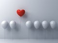 One red heart balloon flying away from other white balloons on white wall background