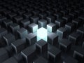 One glowing light cube shining among other dim cubes in the dark night background with reflections Royalty Free Stock Photo