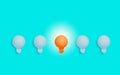 Stand out from the crowd. Outstanding unique orange light bulb glowing. Royalty Free Stock Photo