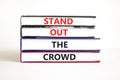 Stand out the crowd symbol. Concept words Stand out the crowd on books on a beautiful white table white background. Business, Royalty Free Stock Photo