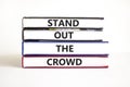 Stand out the crowd symbol. Concept words Stand out the crowd on books on a beautiful white table white background. Business, Royalty Free Stock Photo