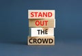 Stand out the crowd symbol. Concept words Stand out the crowd on wooden blocks on beautiful grey table grey background. Business, Royalty Free Stock Photo