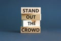 Stand out the crowd symbol. Concept words Stand out the crowd on wooden blocks on beautiful grey table grey background. Business, Royalty Free Stock Photo