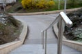 Stand in the park made of concrete with a handle made of shiny, stainless steel metal pipes. lower railing is a protection against Royalty Free Stock Photo