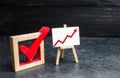 Stand with a red up arrow and a check mark. The concept of high voter turnout, the growth of statistical indicators. Voting, high Royalty Free Stock Photo