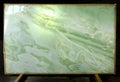 On the stand is a slab of natural stone Verde Onyx, which is backlit