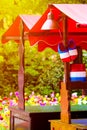 Stand with traditional Holland symbols in national colors taken against sunset light. Blurred colorful tulips in the background.