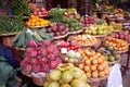 Stand with tropical fruit on the market - bananas, avocados, tomatoes, mangos, passion fruits and oranges. Funchal, Madeira Royalty Free Stock Photo