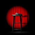 Stand up comedy show - microphone and stool in ray of spotlight and curtain