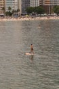 Stand up paddle board man paddleboarding . Young caucasian male model on Copacabana beach on summer holidays vacation trave Royalty Free Stock Photo