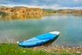 Stand up paddle board SUP at the edge of a smarald/green, isolated, secluded lake, with warm sunset light - Iacobdeal lake.