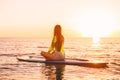 Stand up paddle boarding on a quiet sea with sunset colors. Relaxing on ocean Royalty Free Stock Photo