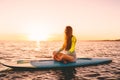 Stand up paddle boarding on a quiet sea with warm sunset colors. Relaxing on ocean Royalty Free Stock Photo