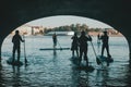 Stand up paddle group on the water float under the bridge, a creative tour of St. Petersburg on the paddle Board, Royalty Free Stock Photo