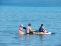 Stand up paddle surfing. A family is riding a board.