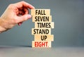 Stand up symbol. Concept words Fall seven times stand up eight on wooden blocks. Beautiful grey table grey background. Businessman