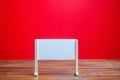 Stand or white board on a red background. Empty whiteboard. Minimalism. Business process concept, strategy planning at meetings